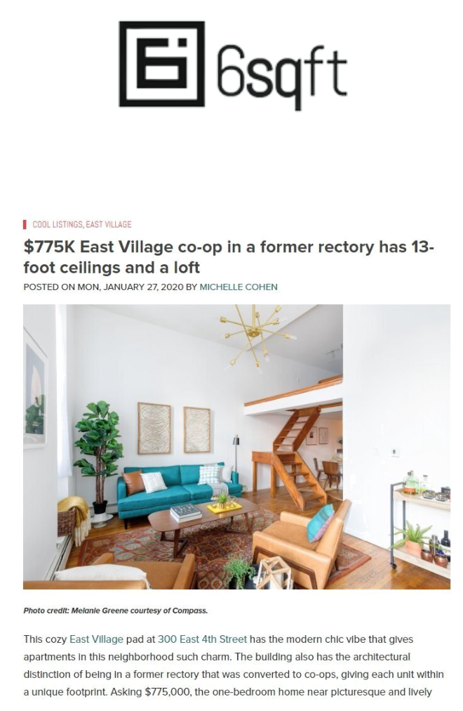 Photo of a living room with a blue sofa, leather chair, coffee table, green plant, wall art, and wooden staircase leading to a loft.