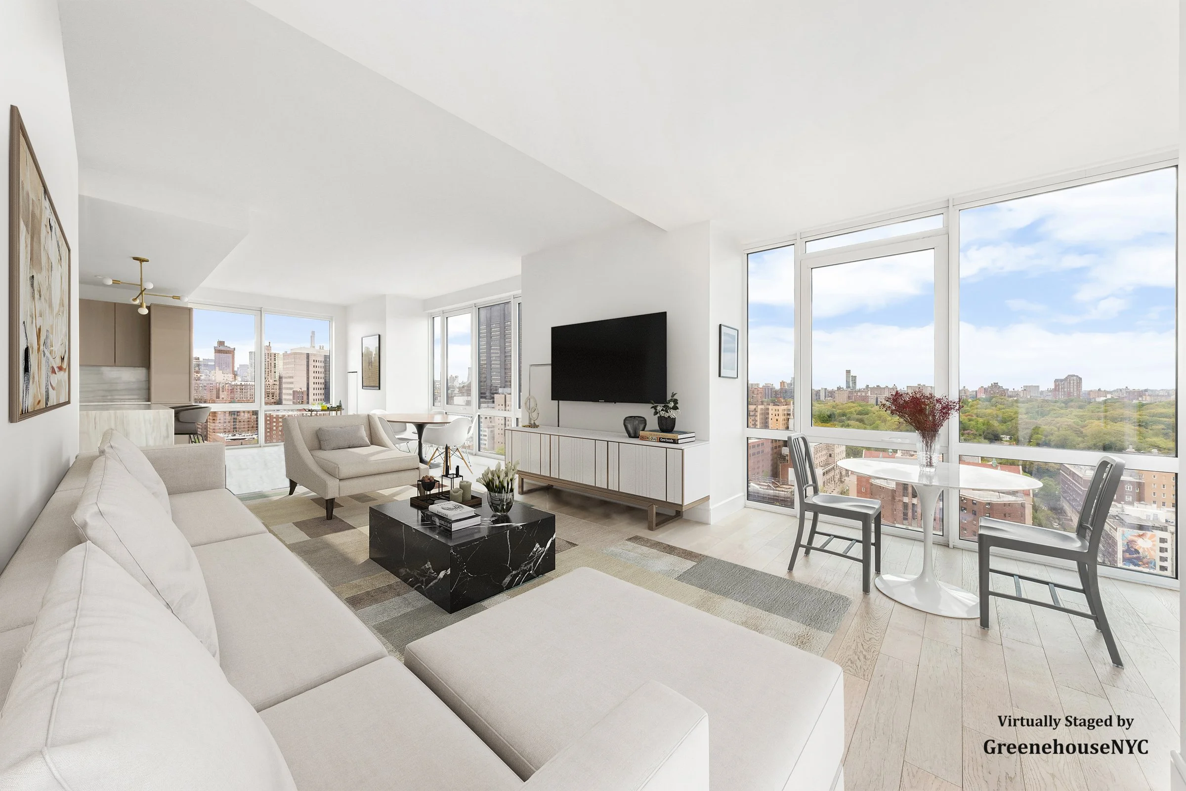 Modern living room with large windows offering city views, white walls and furniture, a black marble coffee table, a wall-mounted TV, and a small dining area with two chairs and a table with flowers.