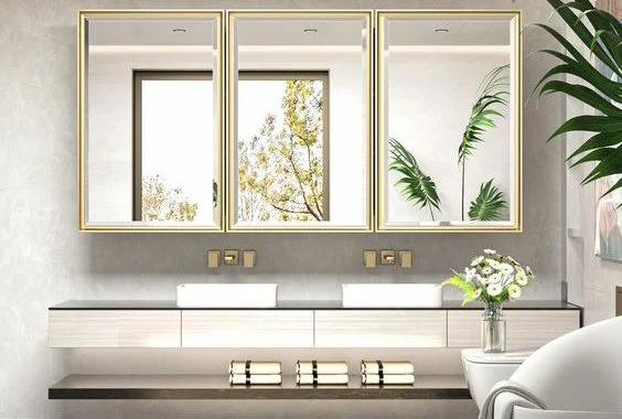 Modern bathroom mirror with three sections, potted plants, and a vase of flowers on a sleek countertop.