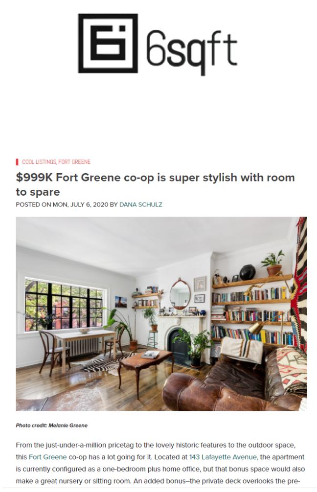 Bright living room with white walls, wooden flooring, a window with black frames, a brown leather couch, a wooden coffee table, bookshelves filled with books, potted plants, and a decorative mirror above a fireplace.