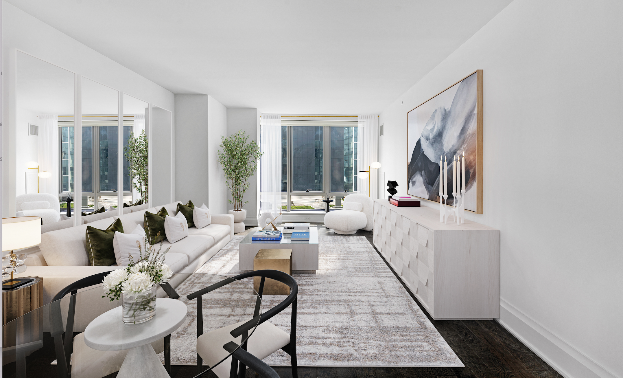 Modern living room with white sofas, decorative pillows, a coffee table, and large windows with white curtains.