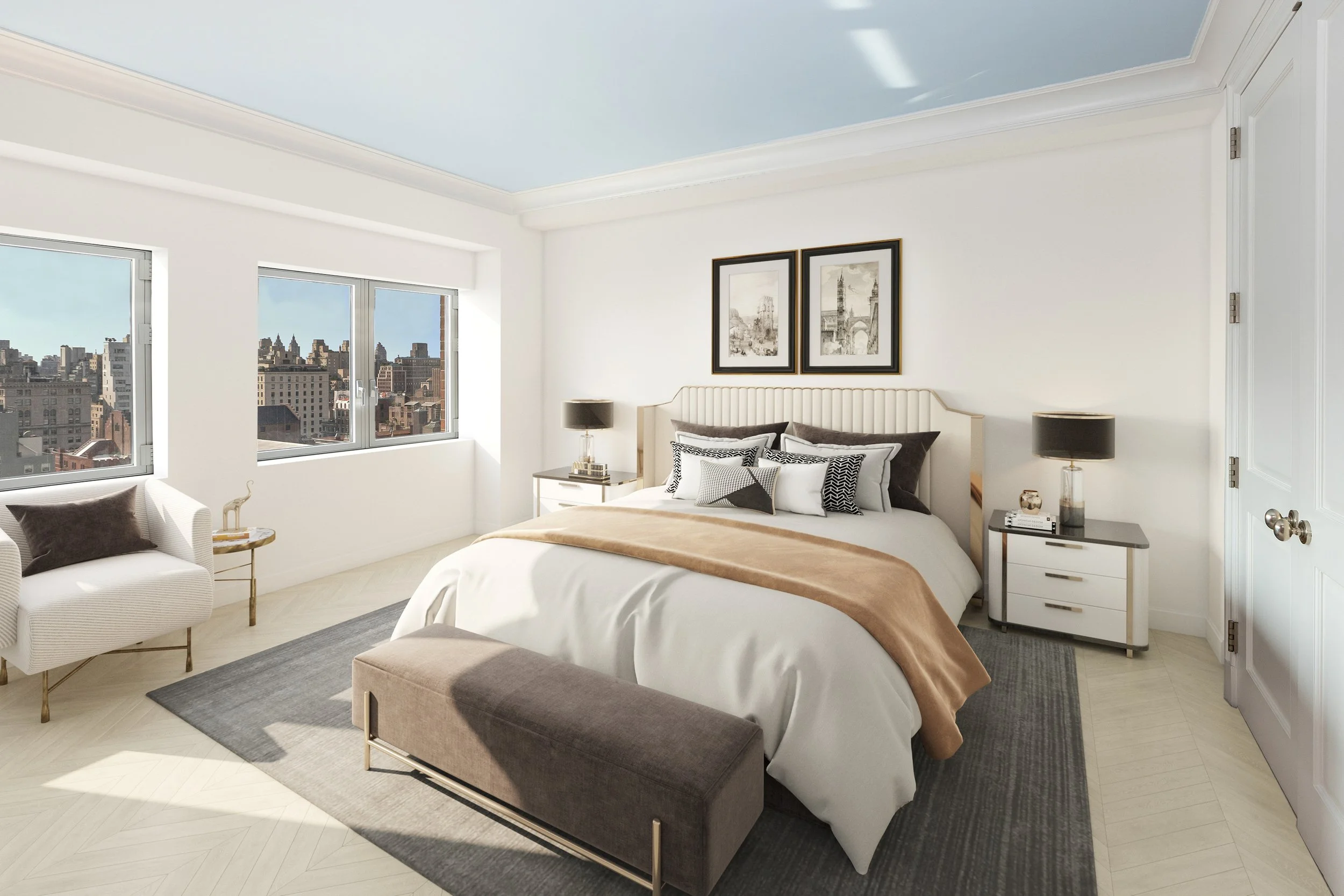 Modern bedroom with white walls, large windows showing city skyline, bed with white and black pillows, beige blanket, two bedside tables with black lamps, and framed black-and-white artwork.