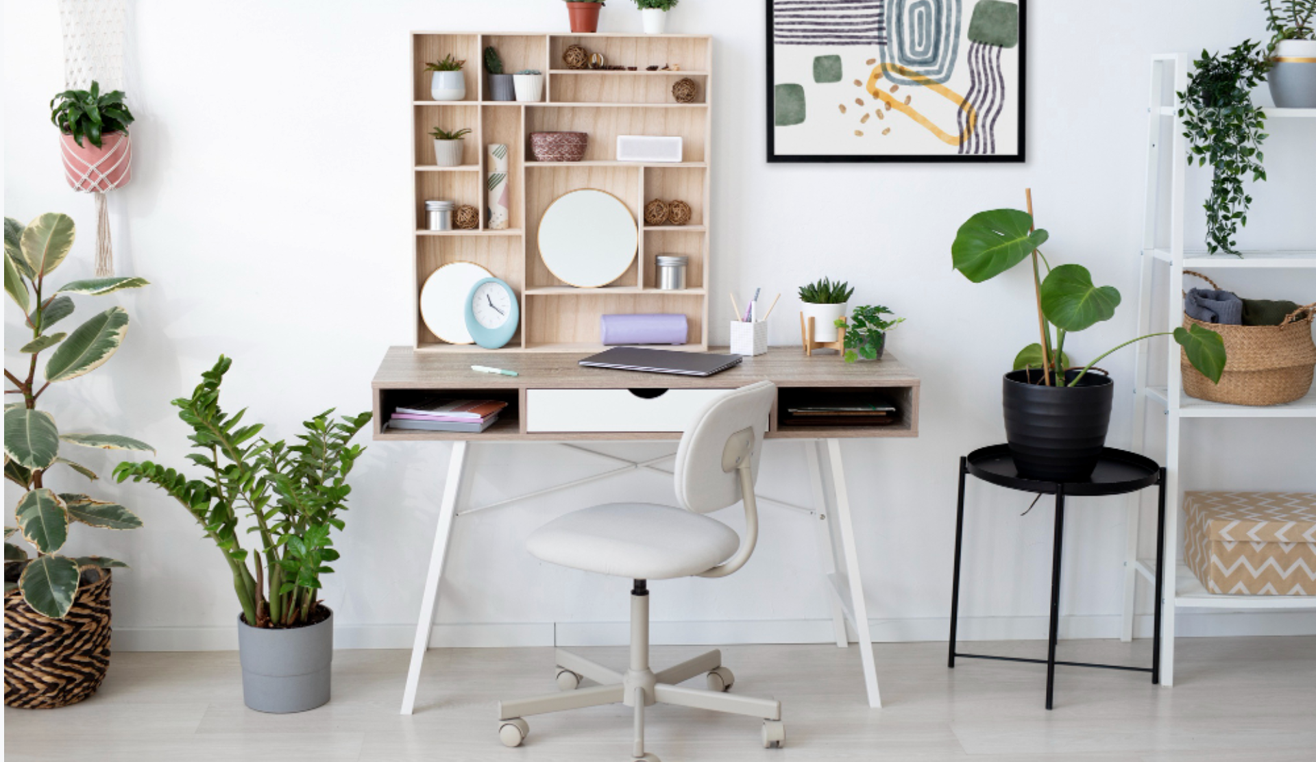 Home office with a desk, white swivel chair, and decorative shelving units with plants, artworks, and storage boxes, surrounded by indoor plants in pots.