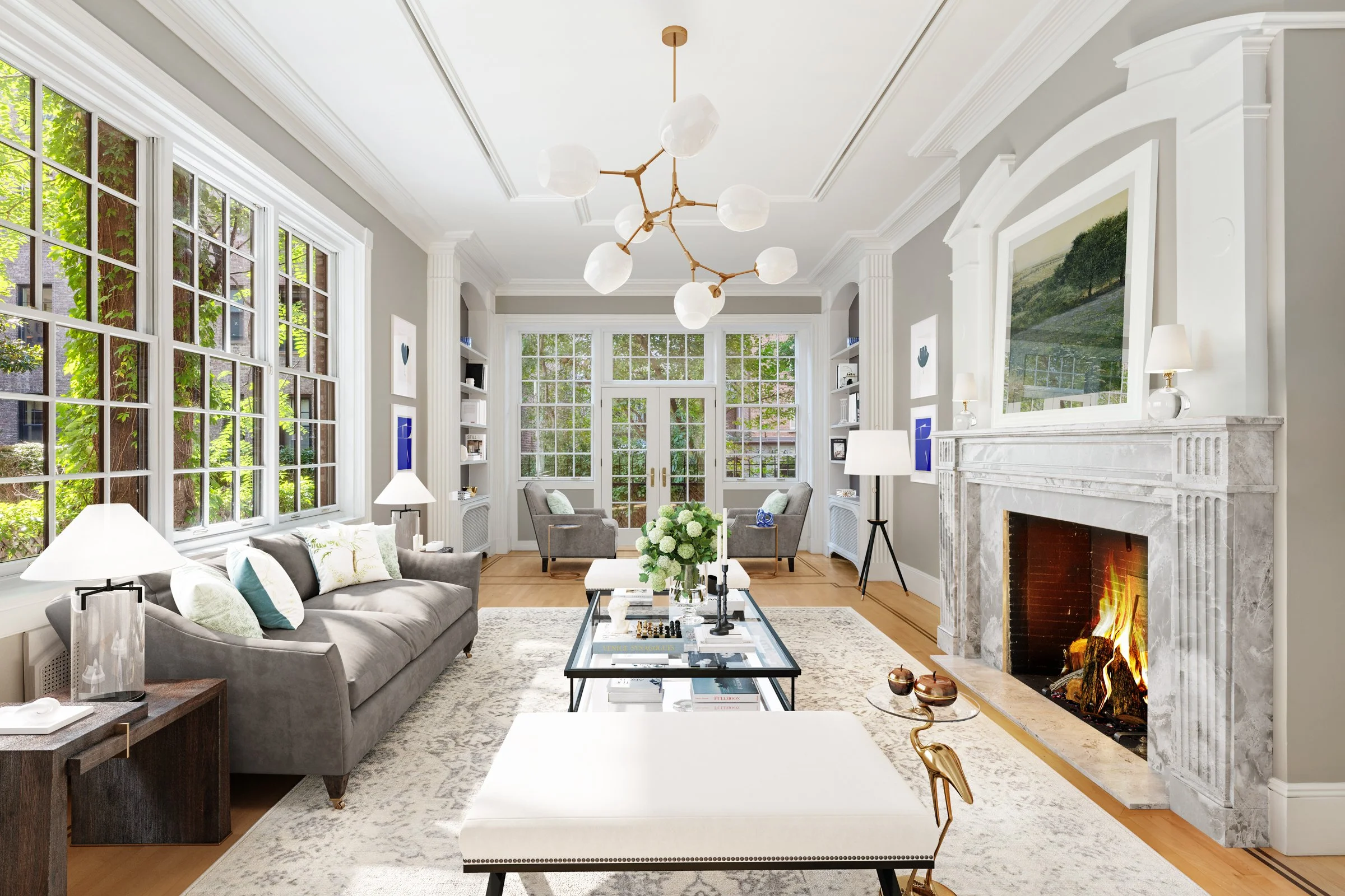 Bright living room with large windows, gray sofa, fireplace, modern chandelier, and neat decor.