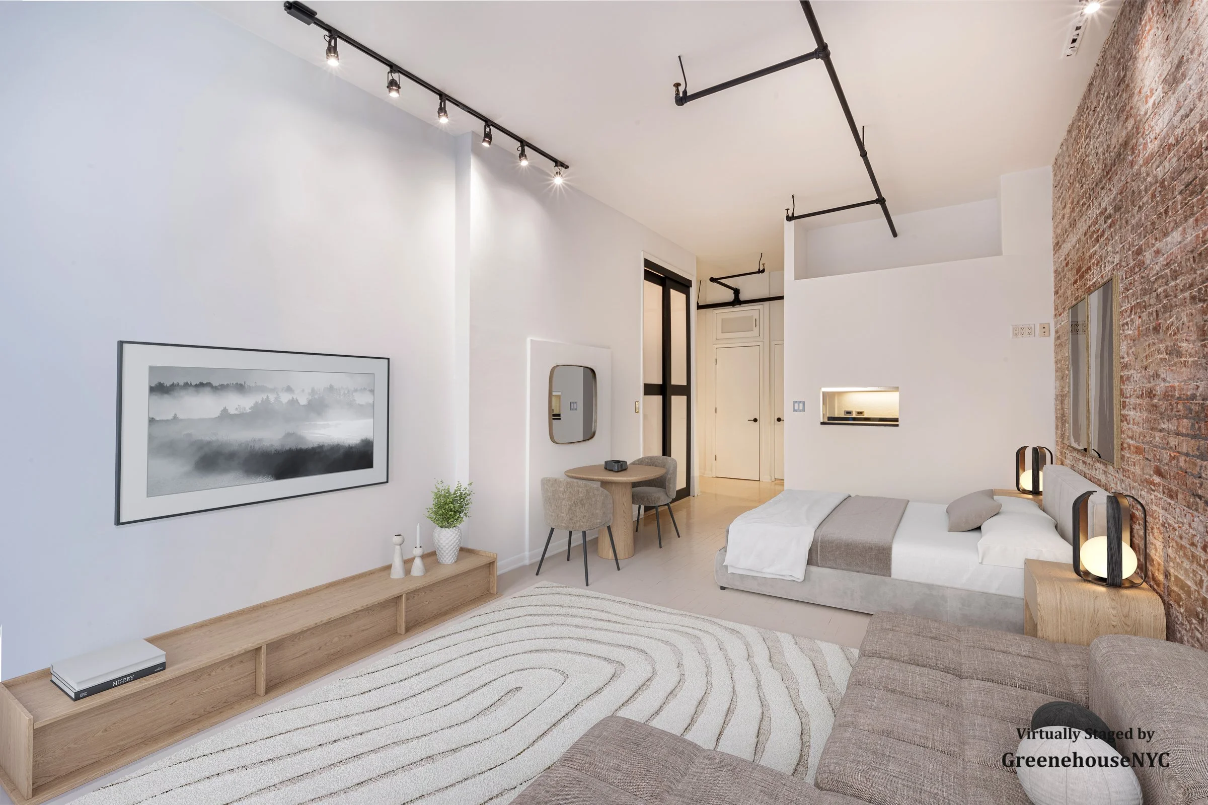 Minimalist bedroom with white and brick walls, a bed with beige bedding, a beige sofa, a wooden side table with table lamps, a wall-mounted art piece, a small wooden table with two chairs, and a white rug with wavy lines underfoot.