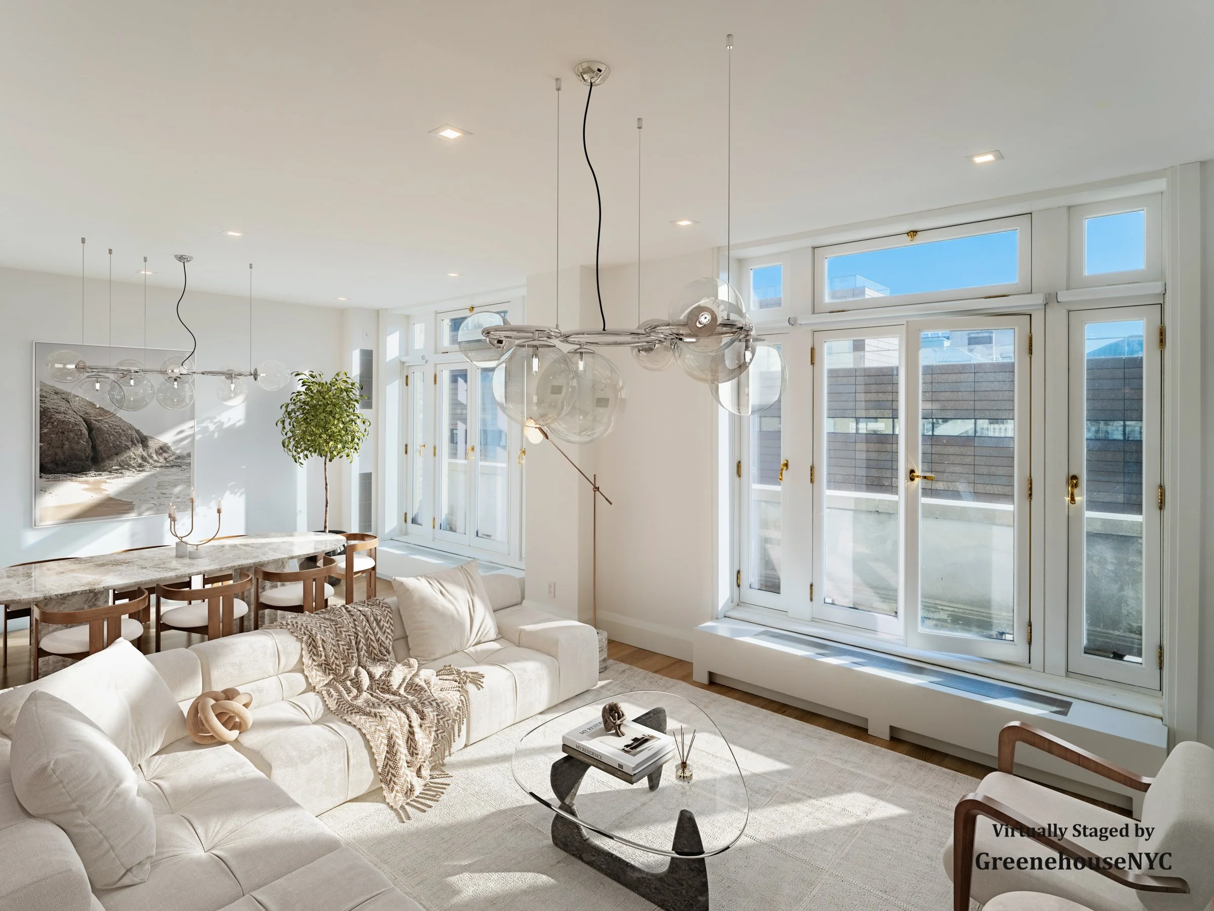 Bright modern living room with white sofas, a glass coffee table, a wall-mounted art piece, large windows with golden hardware, a dining area with a marble table and wooden chairs, a tall potted plant, and contemporary lighting fixtures.