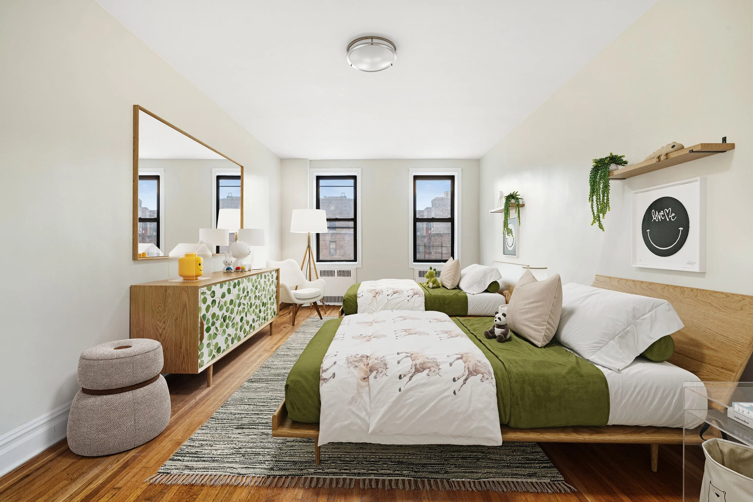 Bright bedroom with two beds, green bedding, and unicorn-themed duvet covers, large mirror, bedside table, plush panda toy, and artwork on the wall.