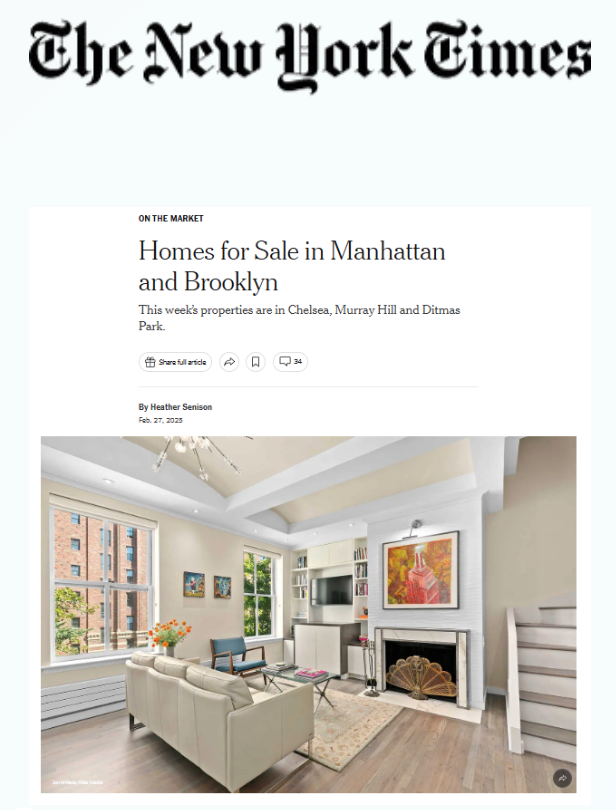 Interior of a living room with white walls, hardwood flooring, a beige sofa, a small coffee table, a fireplace with artwork above it, a television, and large windows showing an exterior brick building and trees.