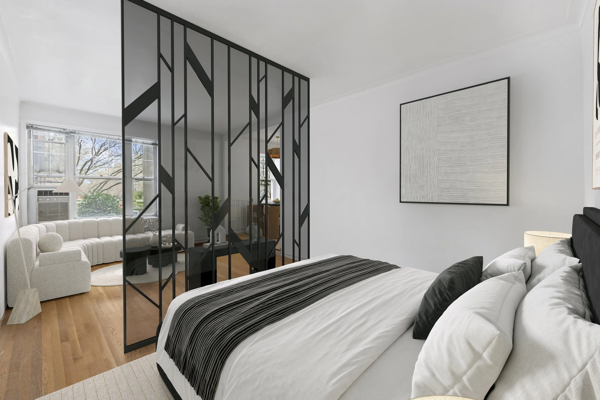 Modern bedroom with black and white decor, a bed with white and black pillows, a black and white striped blanket, and a black metal room divider. The room has a large window, wooden floors, and abstract wall art.