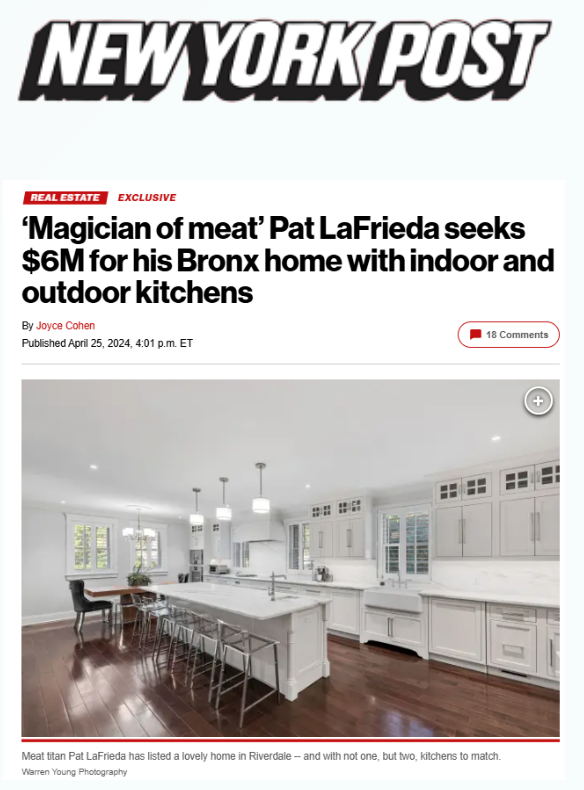 A modern white kitchen with an island, barstools, and hardwood floors.