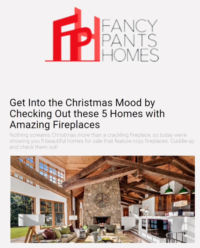 Logo for Fancy Pants Homes with red and gray text and a graphic of buildings, promotional message about Christmas fireplaces and five homes with cozy fireplaces, and an interior photo of a living room with a stone fireplace, high wooden ceilings, and large windows.