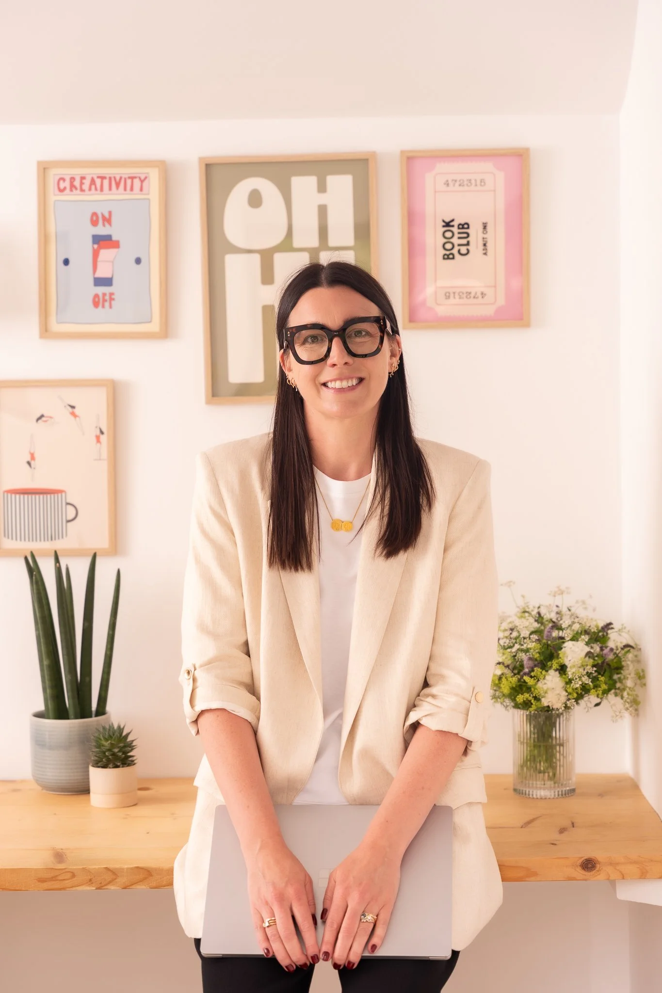 Harriet in her office wearing a cream coloured blazer