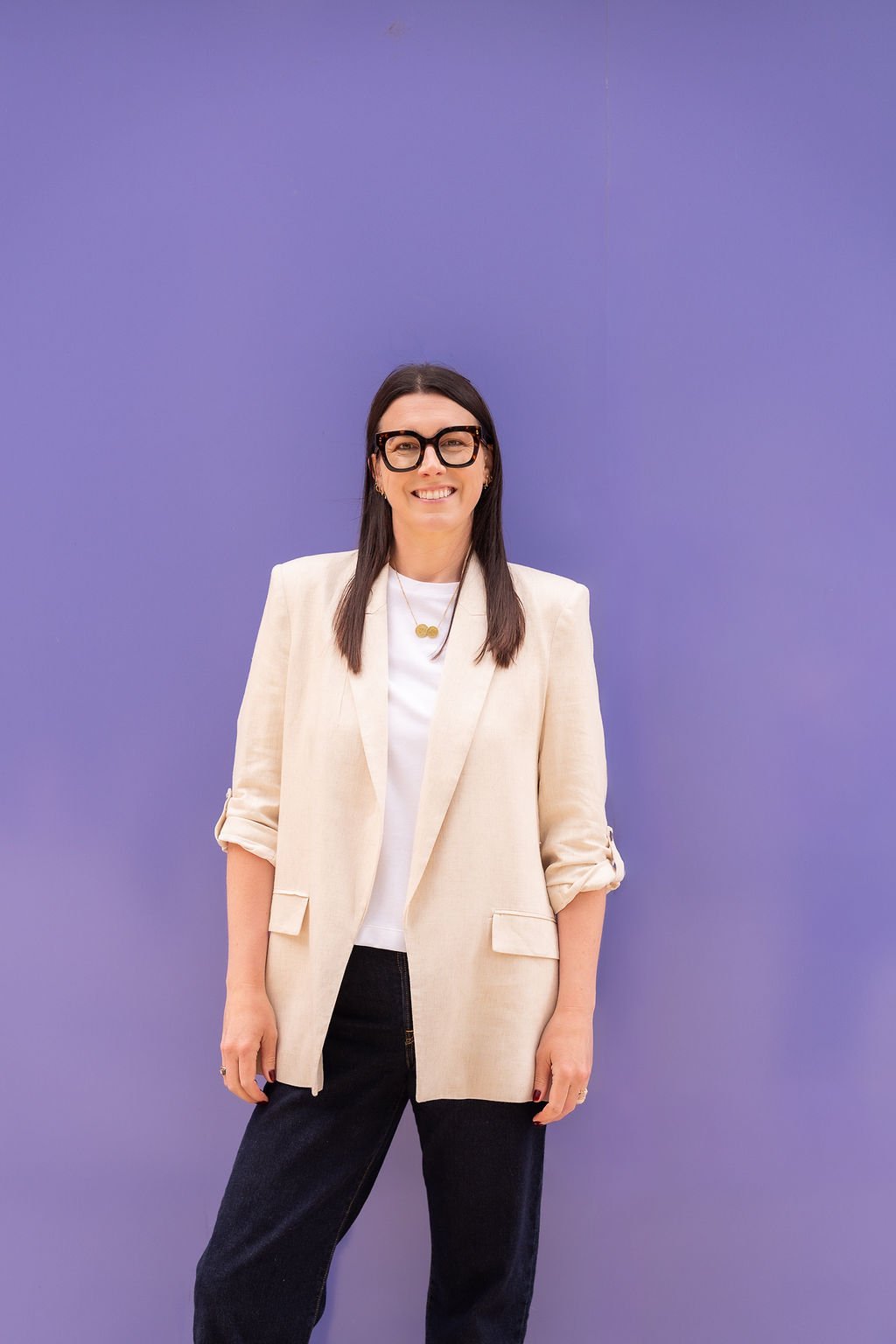 Harriet Cox stood against a purple wall