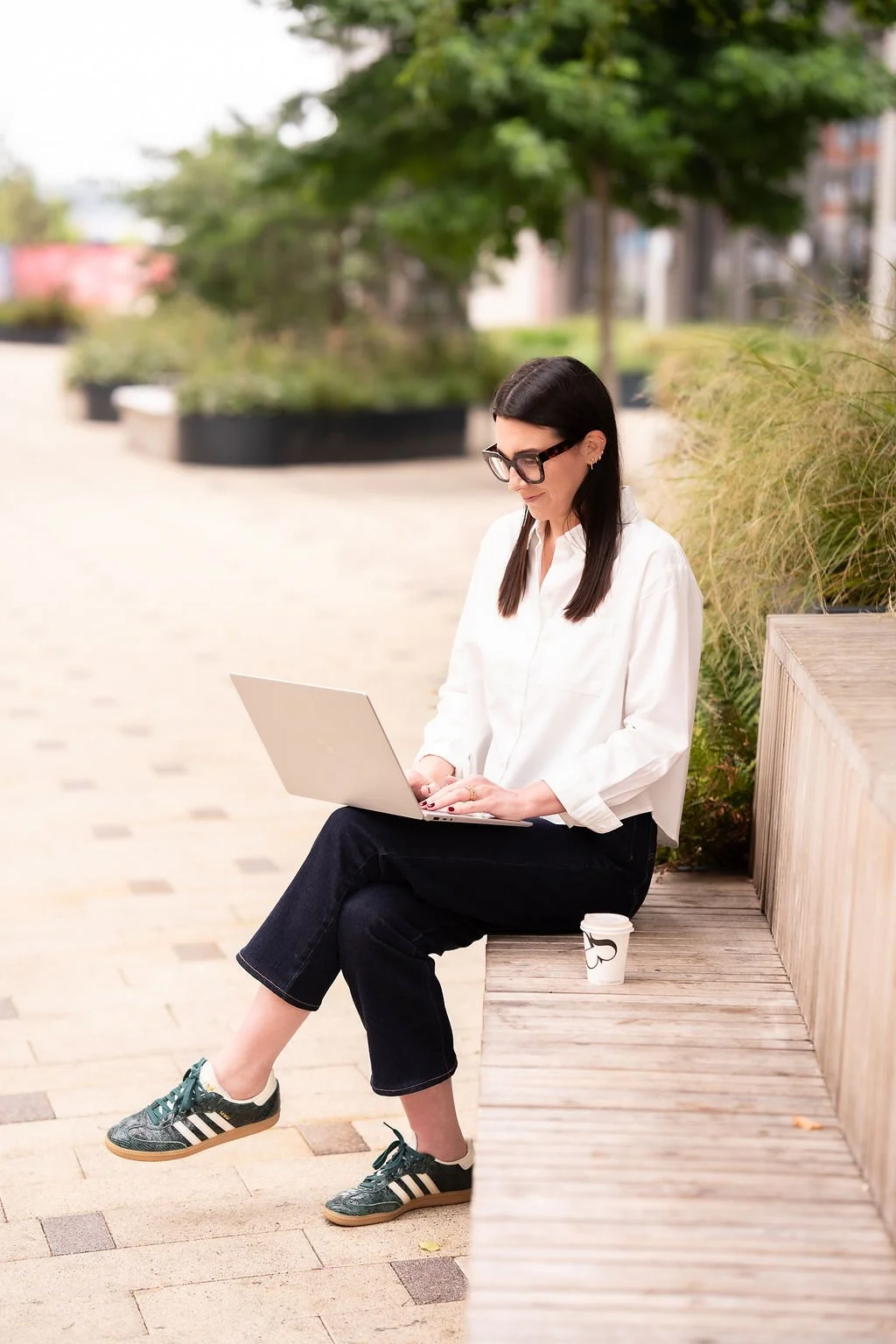 Harriet Cox smiling and typing on her laptop
