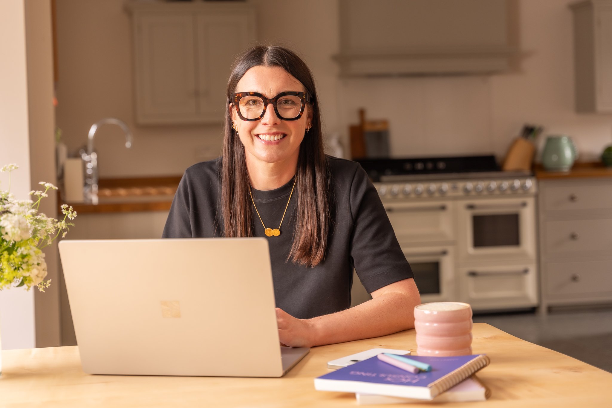 Harriet Cox Sat in front of her PC smiling