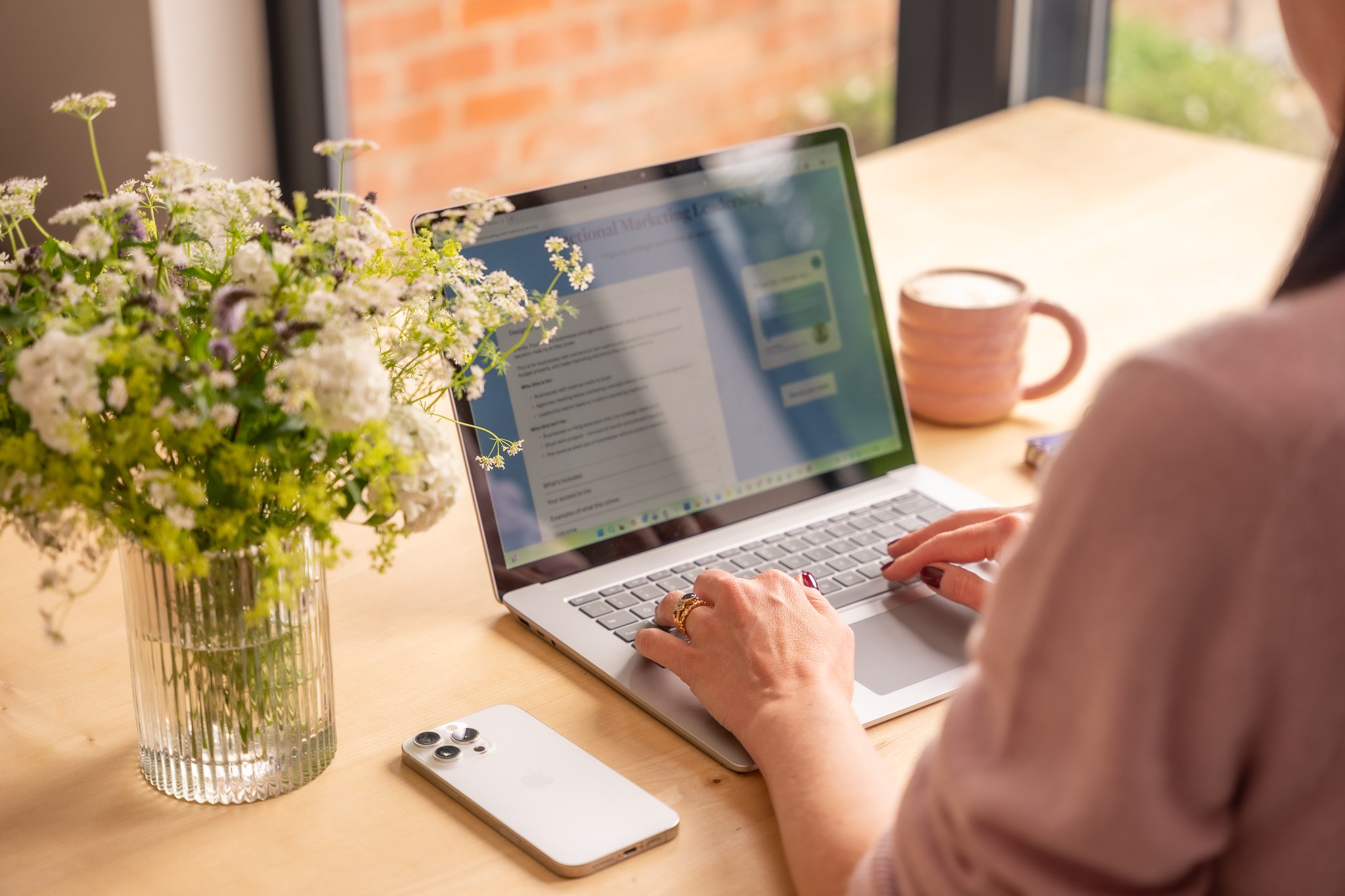 Harriet sat at the table typing on her laptop