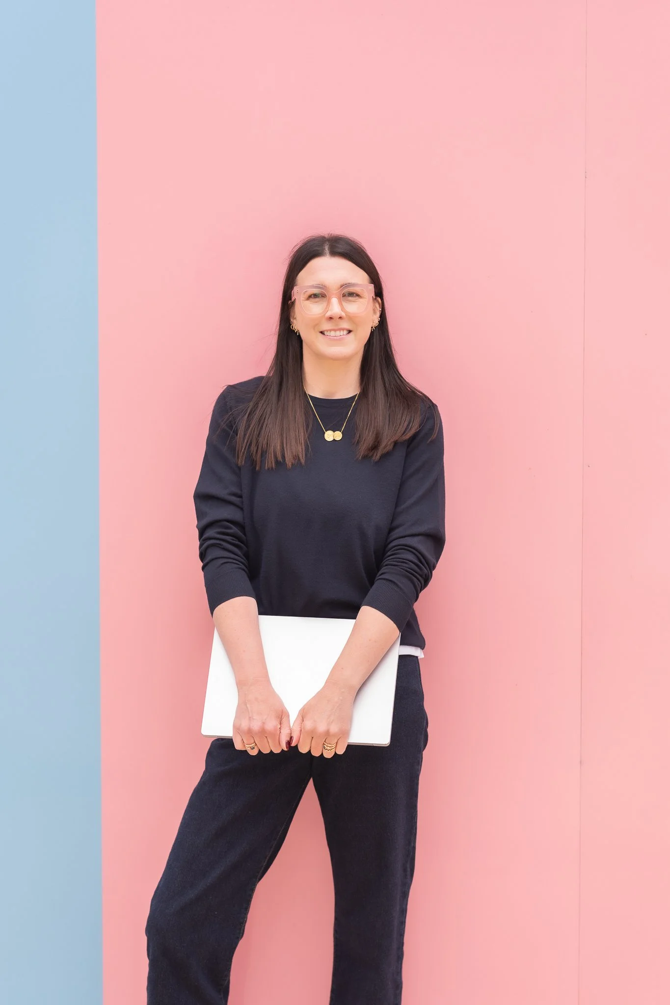 Harriet Cox stood in front of a pink wall