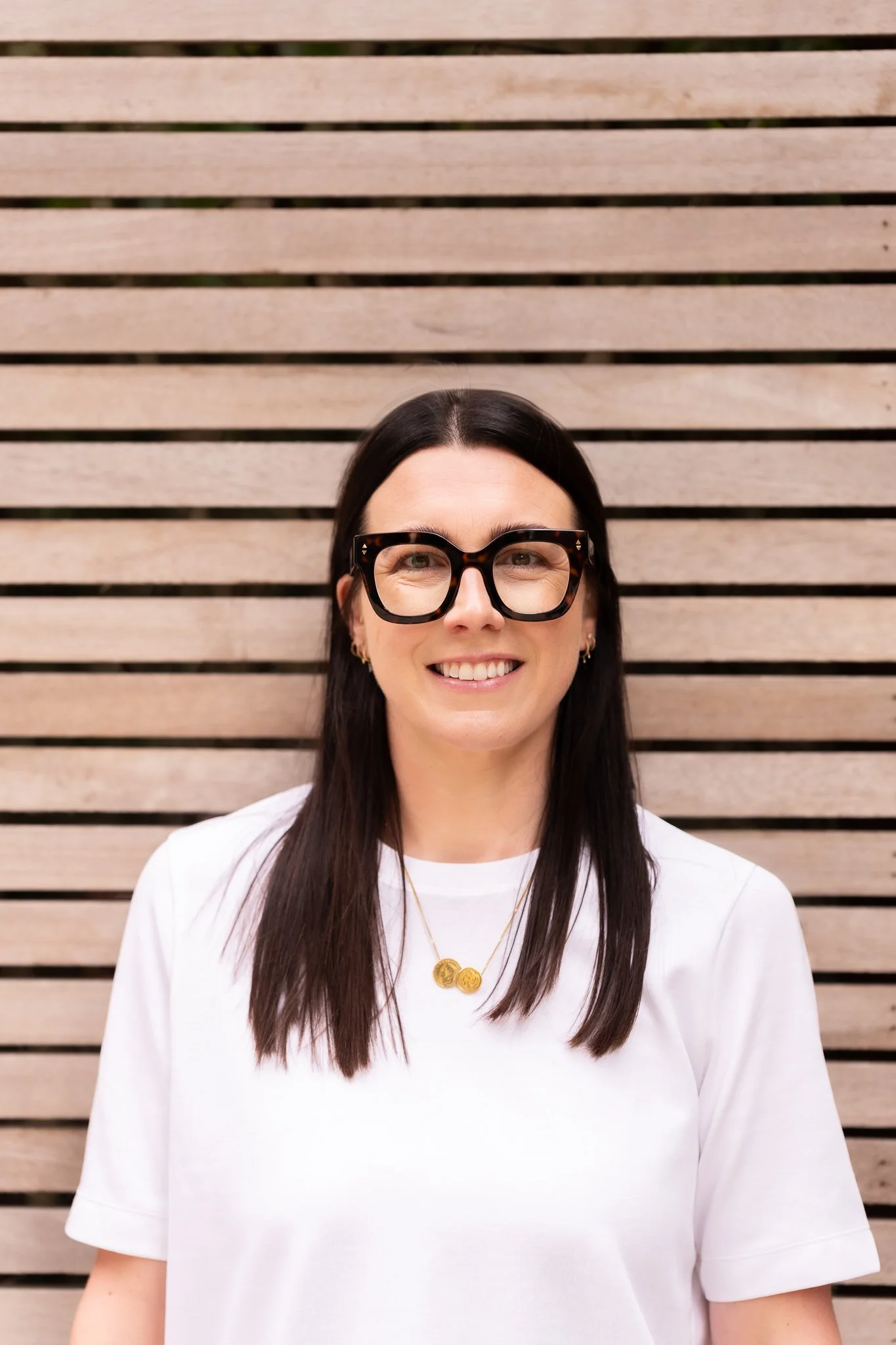 Harriet stood next to a slatted wooden wall