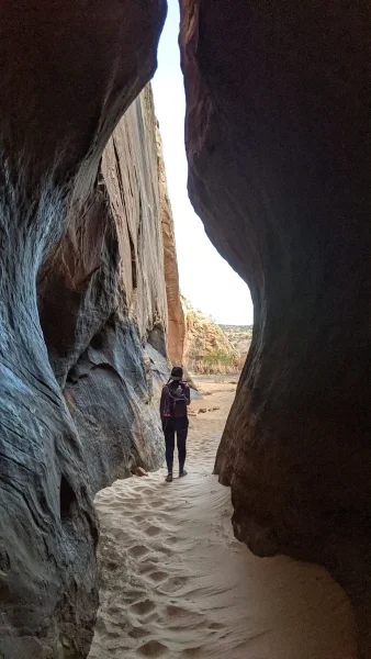 Person walking through a slot canyon