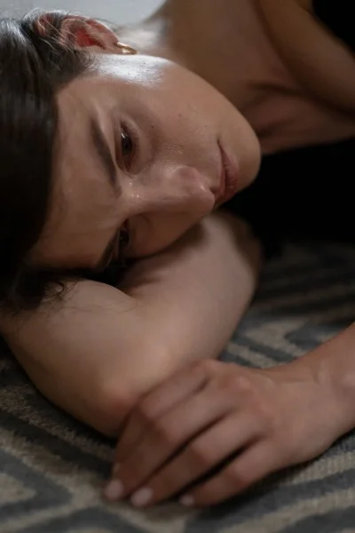 Close up of person laying down looking sad