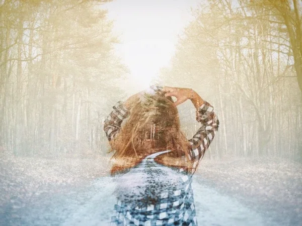 Abstract image of woman with hands on head standing in a road