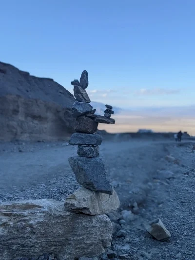 Complex stack of rocks on a beach at sunset