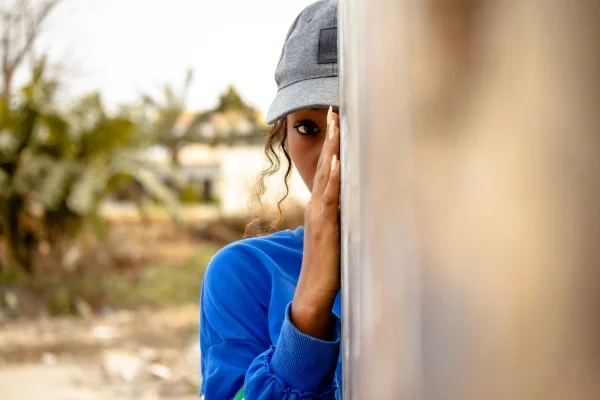 Person peeking from behind a wall