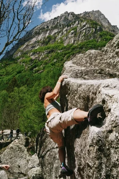 Person rock climbing in steep mountains