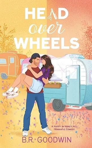 Book cover for 'Head Over Wheels' by B.R. Goodwin, featuring a young couple embracing in front of a blue camper trailer with a pink and orange sunset background and flowers.