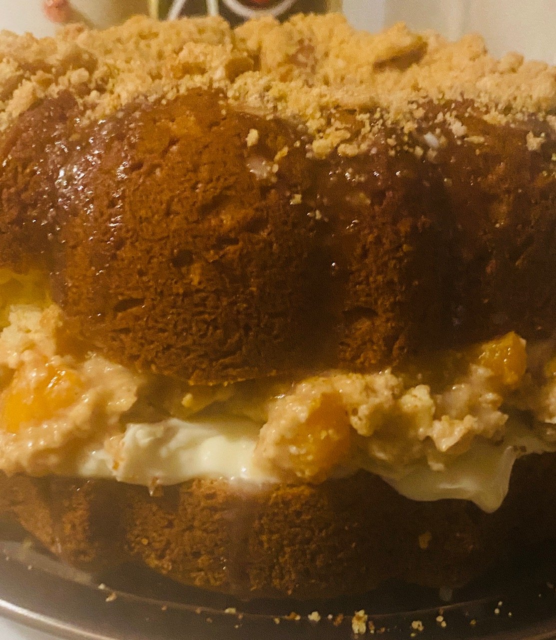 A rich peach cobbler pound cake with a cream‑cheese–stabilized peach filling and buttery streusel. Moist, tender, and perfect for holidays, gatherings, or gifting.