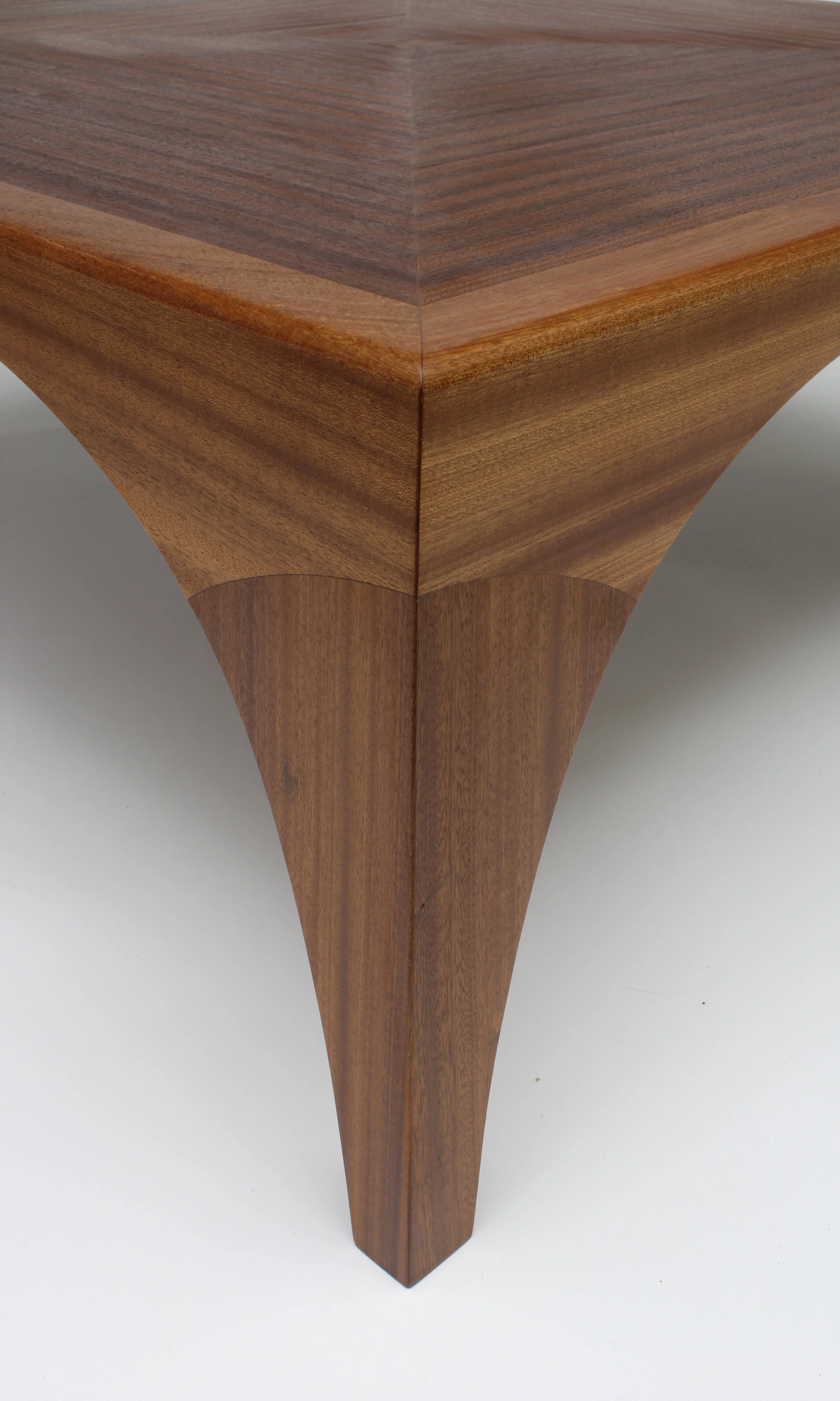 Handcrafted Janus coffee table by Toryn Black Design, made from sapele with a geometric veneer pattern on the tabletop and sculptural parabolic-arched aprons and legs. This contemporary fine-wood furniture piece combines traditional woodworking techn