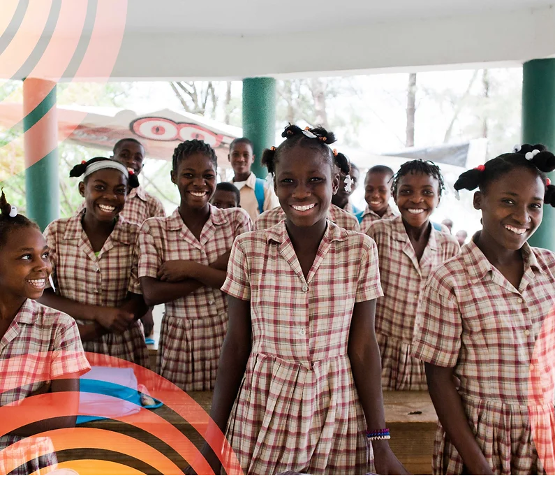 Group of adolescent African school girls smiling.png