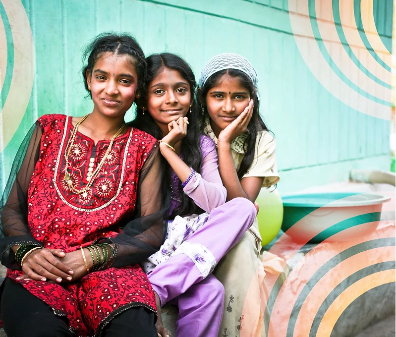 Three adolescent Indian girls smiling.png