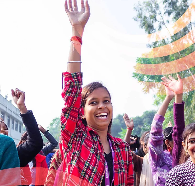 Adolescent girl smiling with hand in the air.png