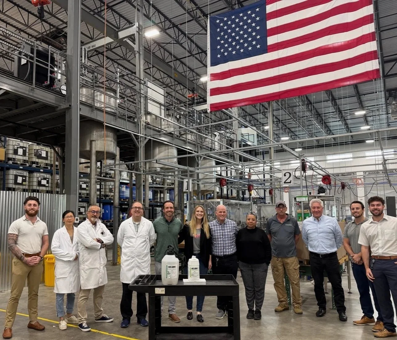 RAVE Power Wash team with Florida Biotech staff at the Manatee County plant under an American flag