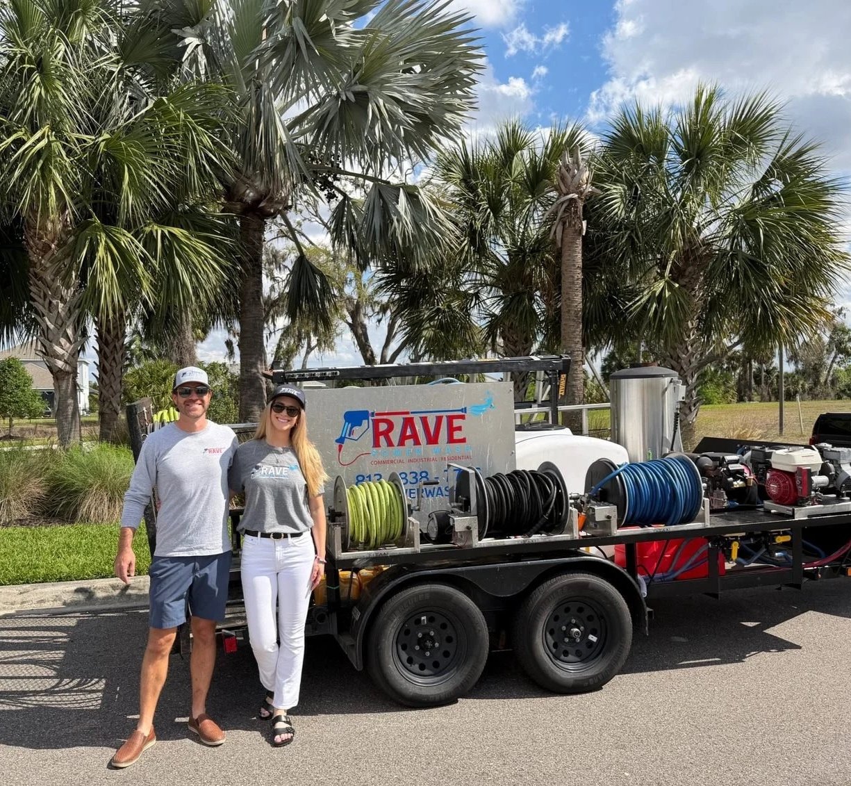 RAVE Power Wash owners standing in front of their pressure washing and soft washing trailer in Southwest Florida