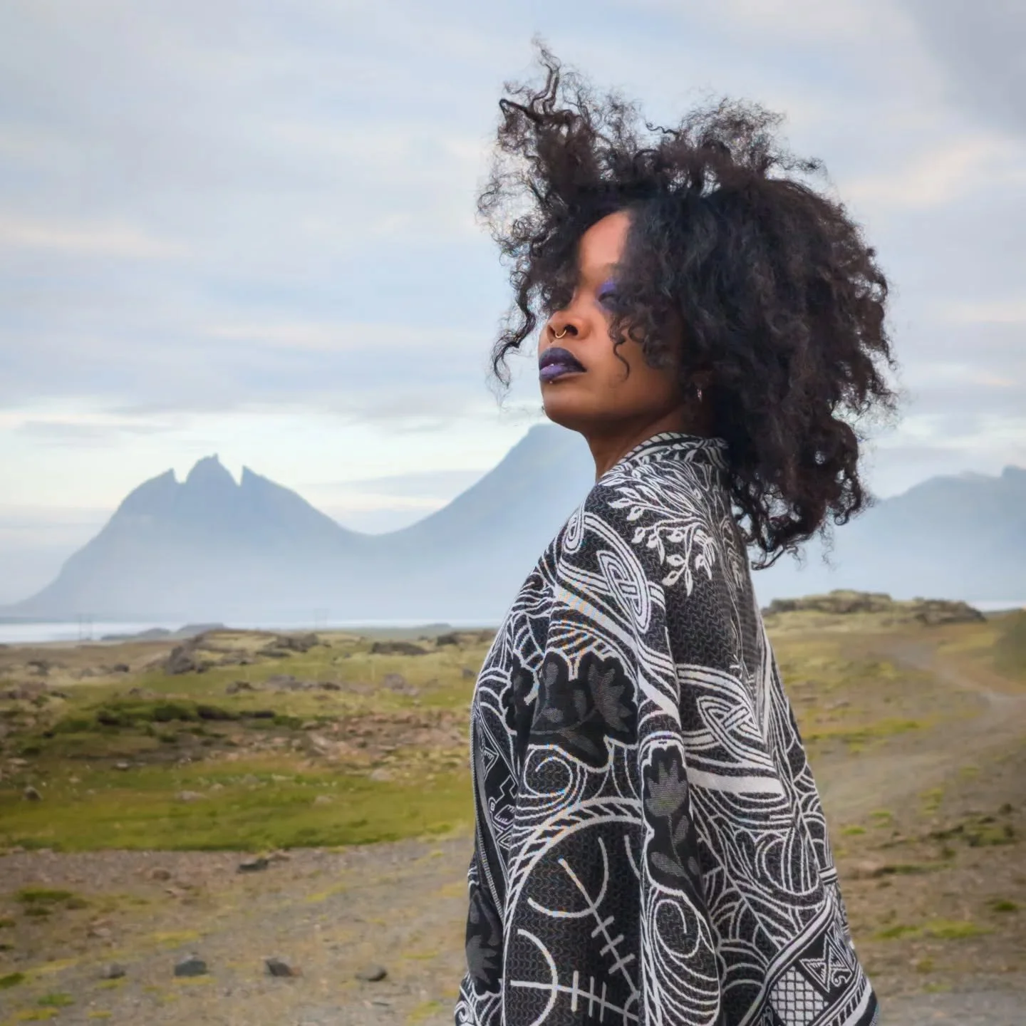 In L&oacute;n, where the veil between worlds wears thin, the wind still remembers the names of dragons.
@blackmagicbarbie stands before Brunnhorn, its peaks rising like the spine of a sleeping wyrm &mdash; a place where the land itself hums with powe