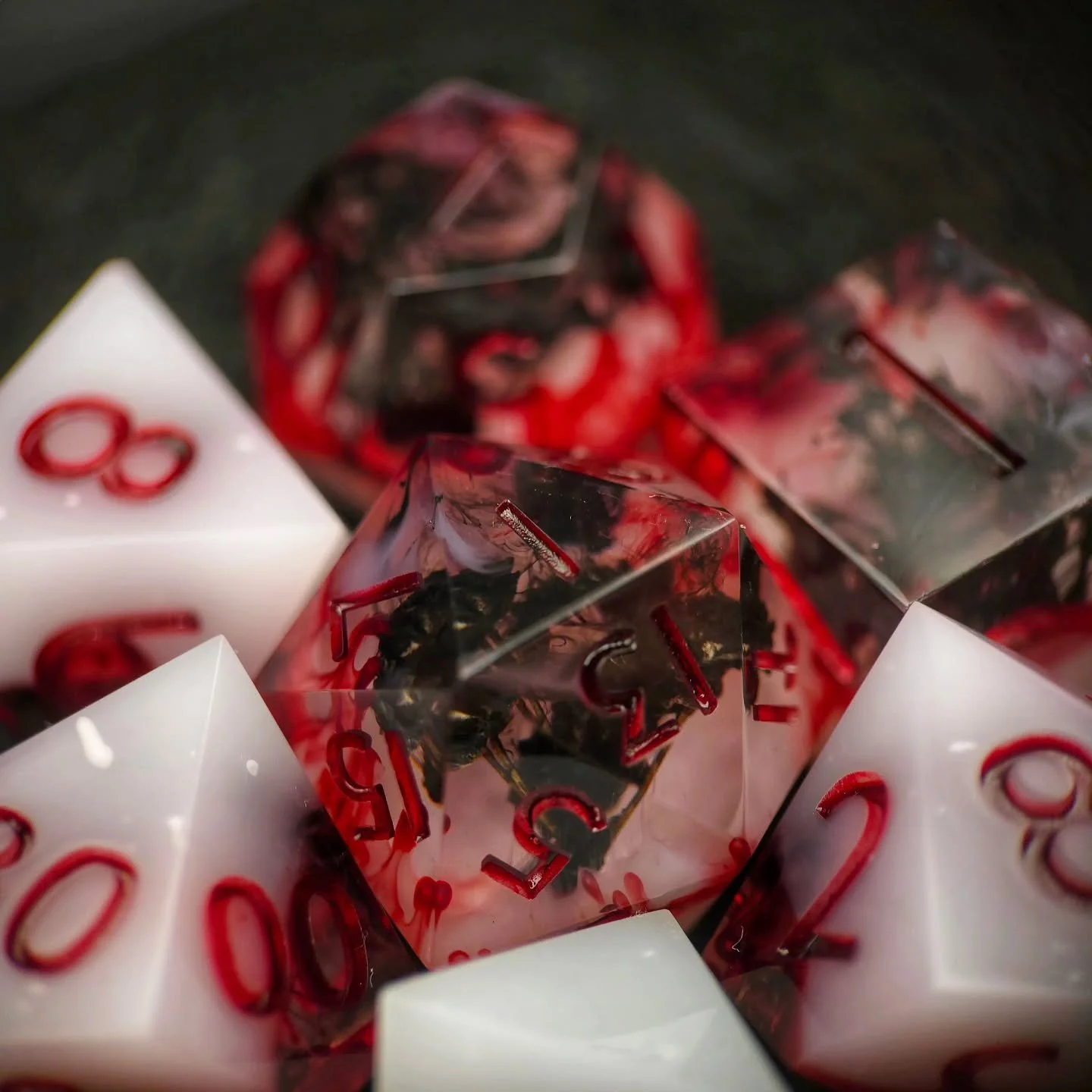 &bull;Mourning in Scarlet&bull; 

These relics were forged in remembrance of a forbidden funeral rite, where grief itself was bound with blood. Black flowers were gathered at dusk, their petals steeped in mourning prayers and pressed into pale resin 