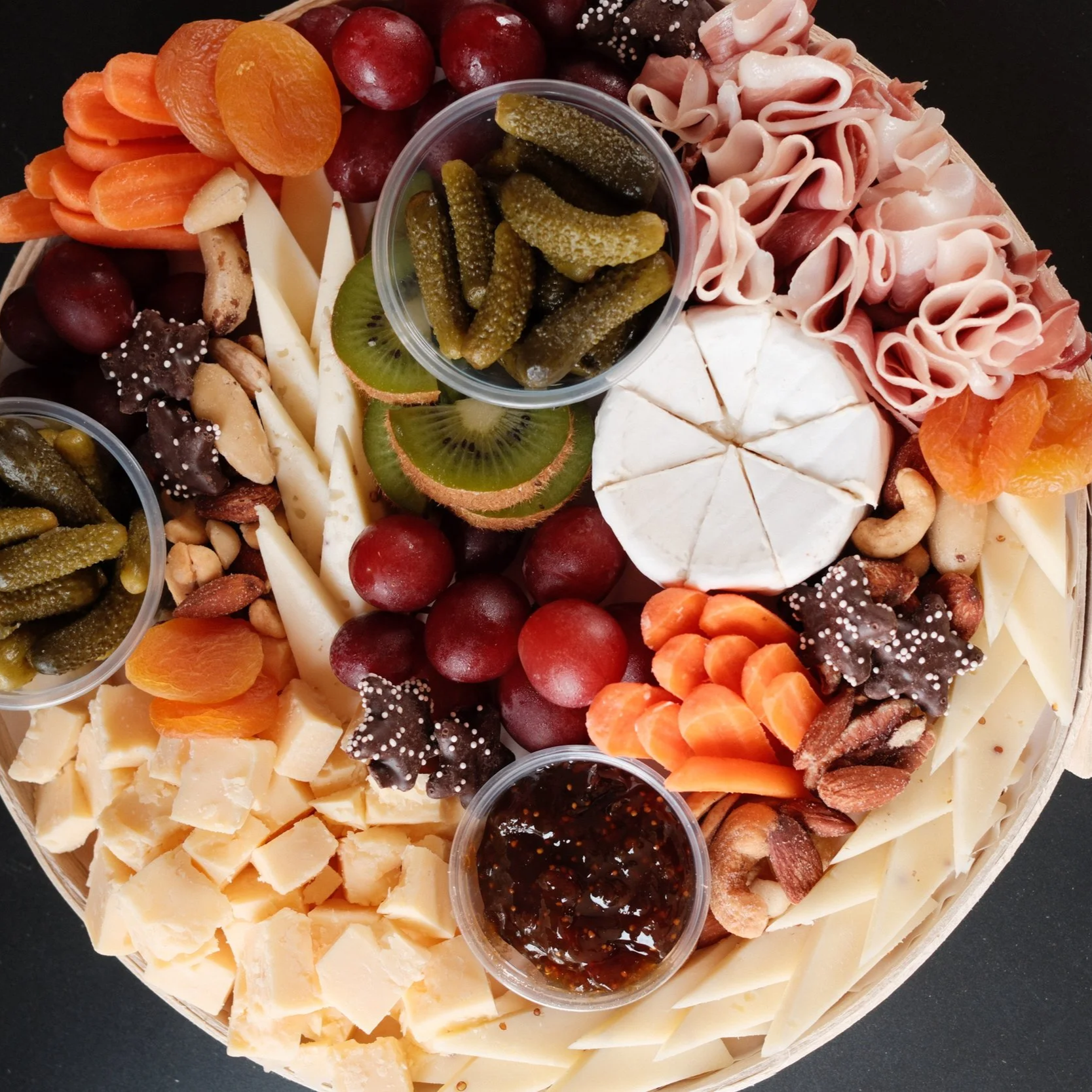 grazing charcuterie board with meat cheese fruits and veggies
