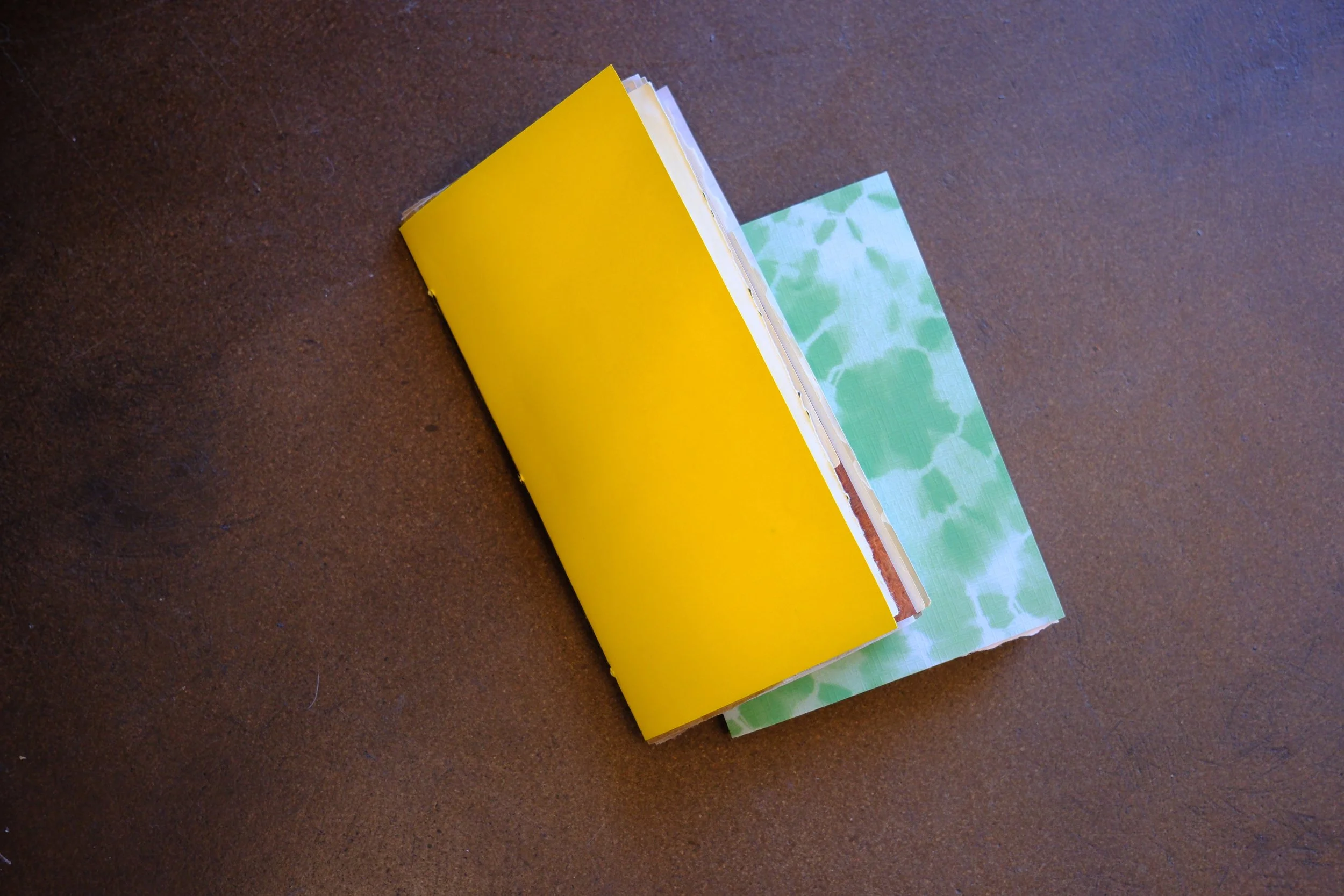 tow homemade journals sitting on a brown background