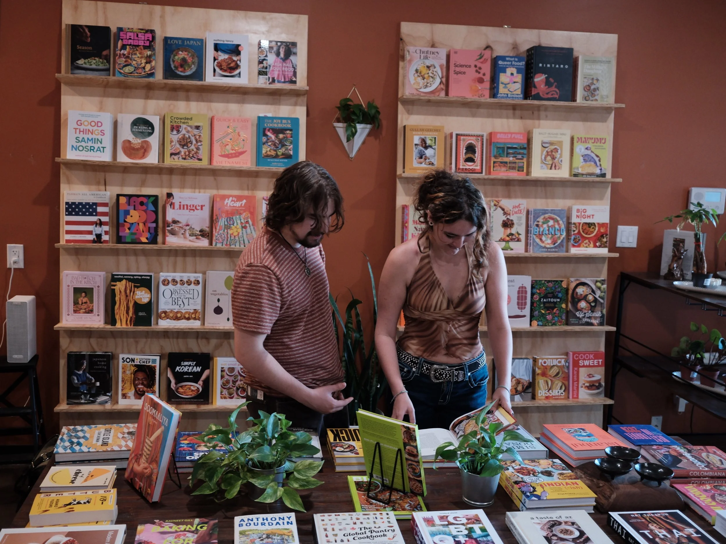 two people looking through cookbooks