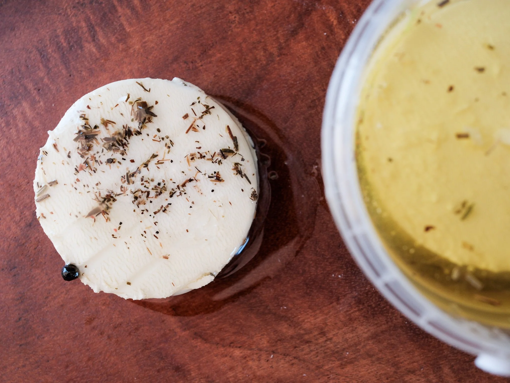 a piece of fresh chevre by laura chenel on a cutting board