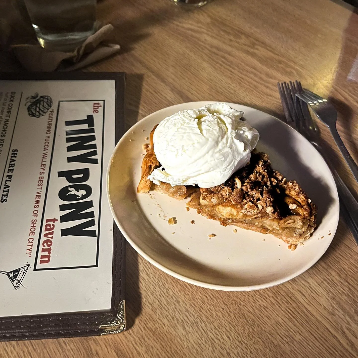 Loaded nachos, glass of wine, slice of pie. 💜