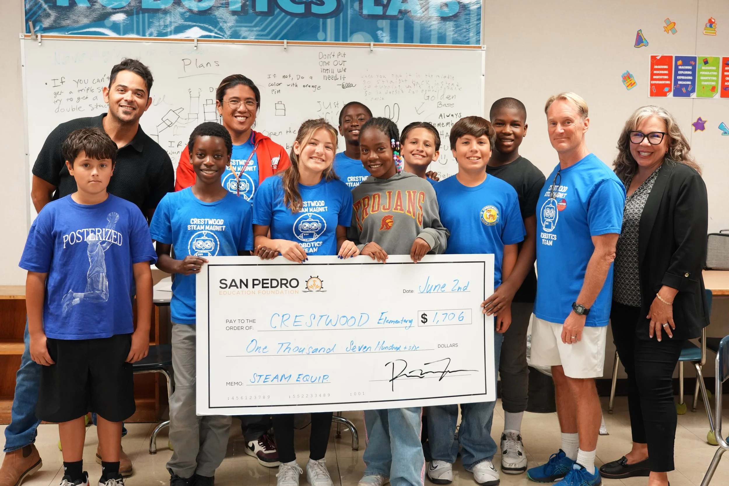 grant check given to students at Crestwood elementary to support their robotics program