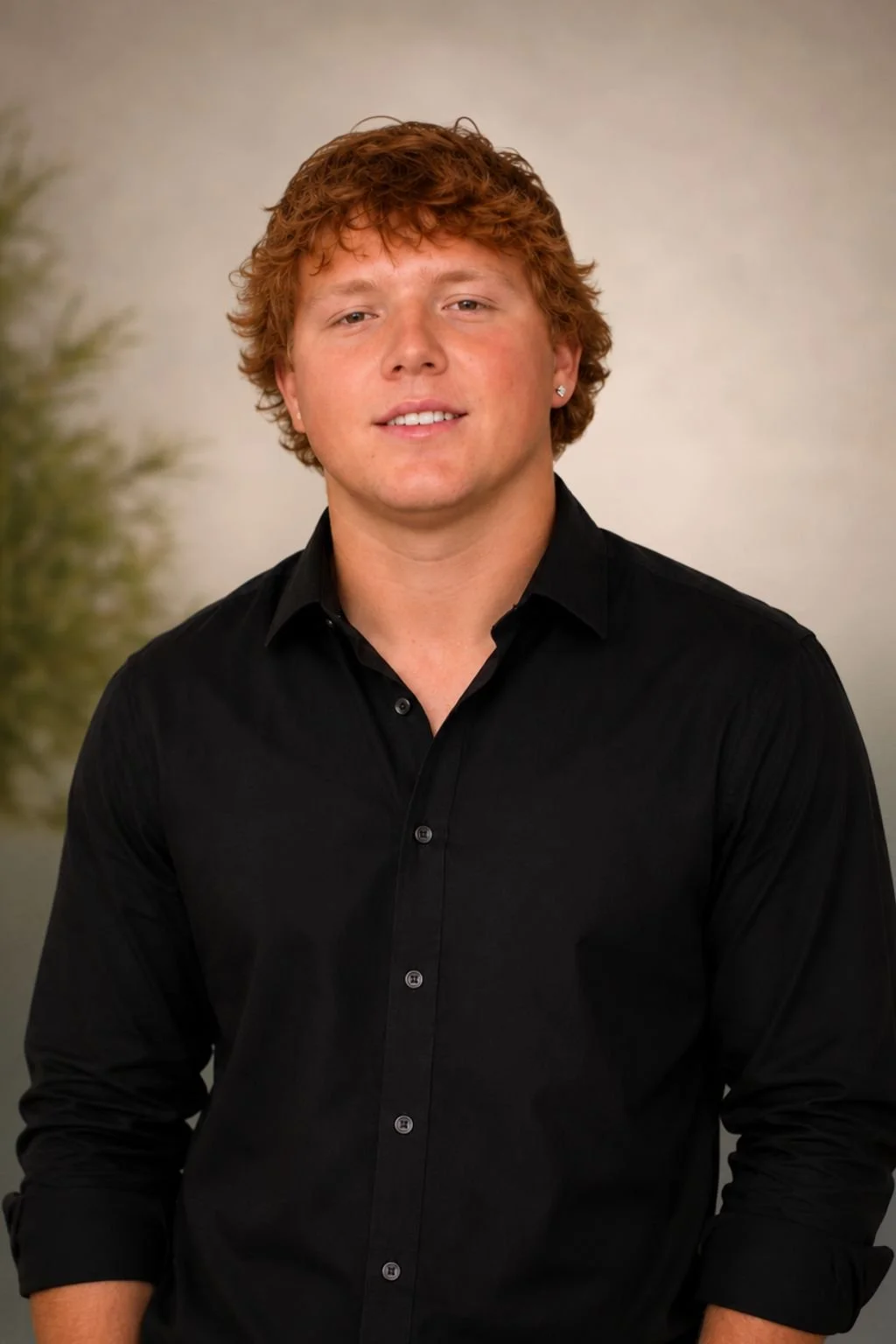 Rhett, wedding and event DJ, smiling in a black button-up shirtIsmael, saxophonist, smiling in a black button-up shirt