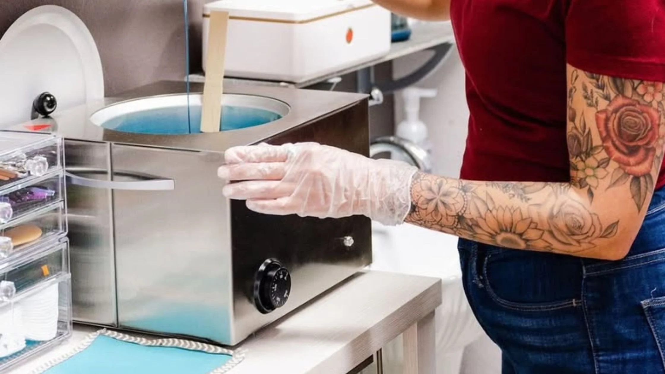 Esthetician preparing hot wax in professional waxing heater for hair removal treatment in salon