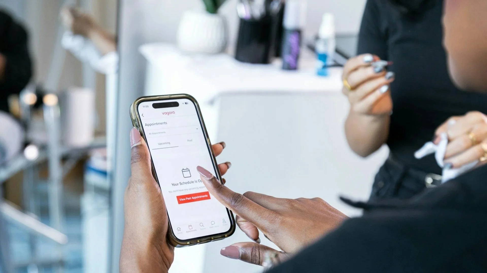 Close-up of a person using a smartphone app to schedule a waxing appointment.