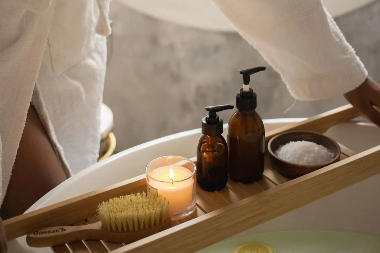 Self-care routine with a bath, body care products, and exfoliating brush