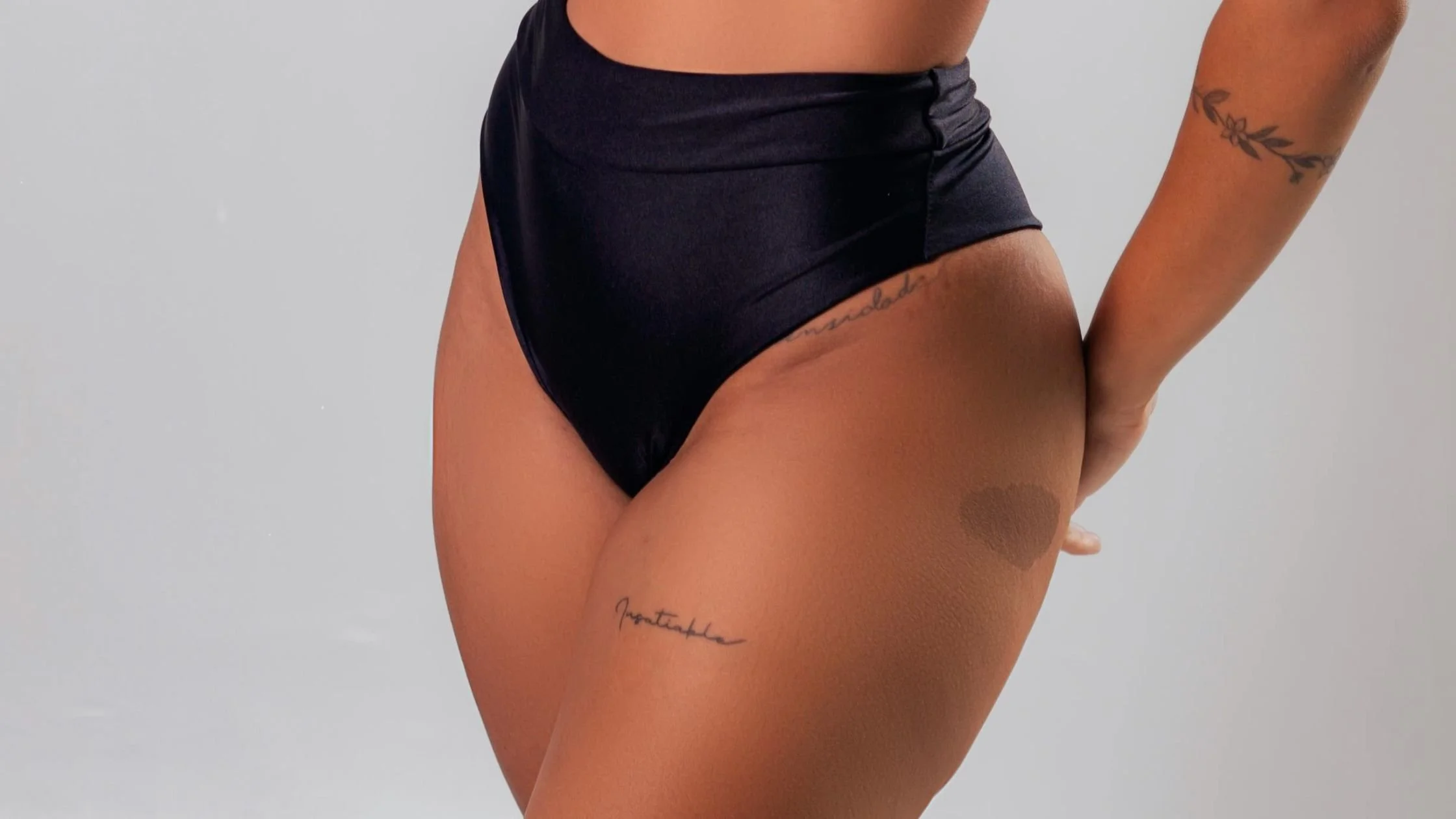Close-up of person’s bikini line and upper thigh in black underwear