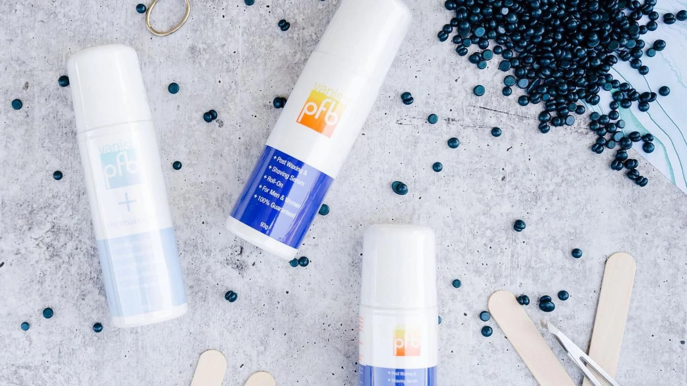 Roll-on post waxing skincare serum bottles arranged on spa treatment surface